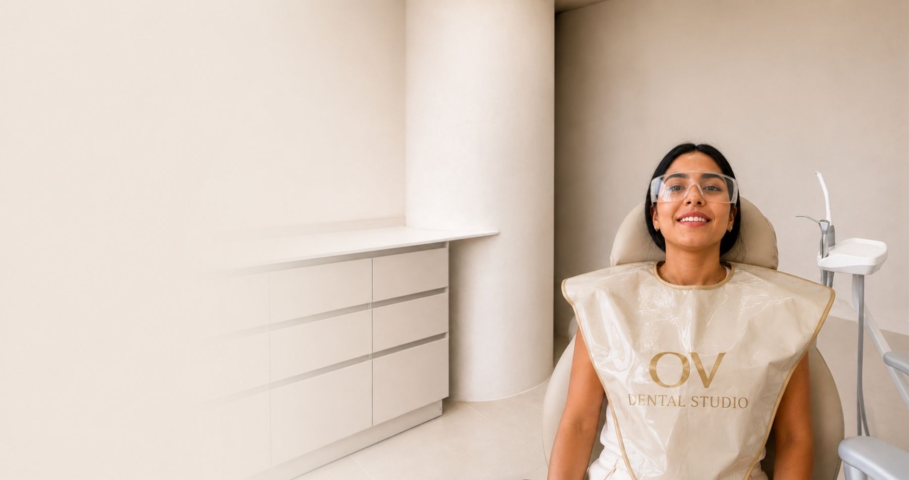 Patient smiling with biosafety protection at OV Dental Studio